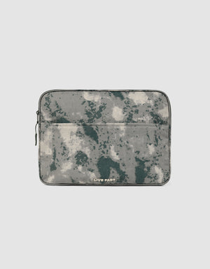 The LFDY Laptop Case by LIVE FAST DIE YOUNG features a gray and green camouflage pattern, a front zip pocket, and a left-side zipper. "LIVE FAST" is printed in white near the bottom center.