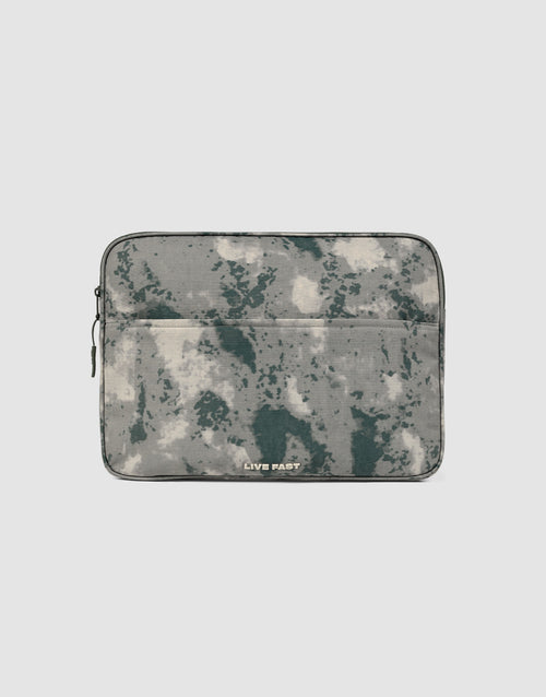 The LFDY Laptop Case by LIVE FAST DIE YOUNG features a gray and green camouflage pattern, a front zip pocket, and a left-side zipper. "LIVE FAST" is printed in white near the bottom center.