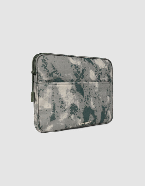 The LFDY Laptop Case by LIVE FAST DIE YOUNG features a gray and dark green abstract camouflage, outer zip pocket, and LIVIN’ DEEP text on the front—a perfect match for your favorite polyester rucksack.