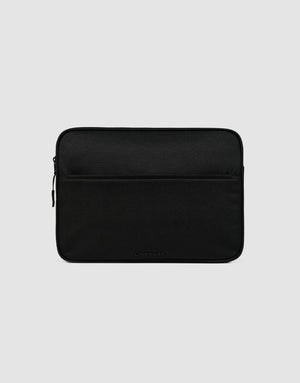 The LFDY Laptop Case by LIVE FAST DIE YOUNG is a black polyester sleeve with a front zippered pocket, shown on a light gray background. It showcases a simple, minimalist design.