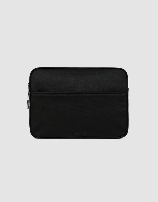 The LFDY Laptop Case by LIVE FAST DIE YOUNG is a black polyester sleeve with a front zippered pocket, shown on a light gray background. It showcases a simple, minimalist design.