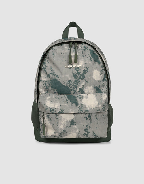 The LFDY Backpack by LIVE FAST DIE YOUNG is a gray-green camouflage 19L laptop rucksack with a large front pocket, black zippers, adjustable shoulder straps, and "LIVE FAST" printed near the top, shown against a plain light background.