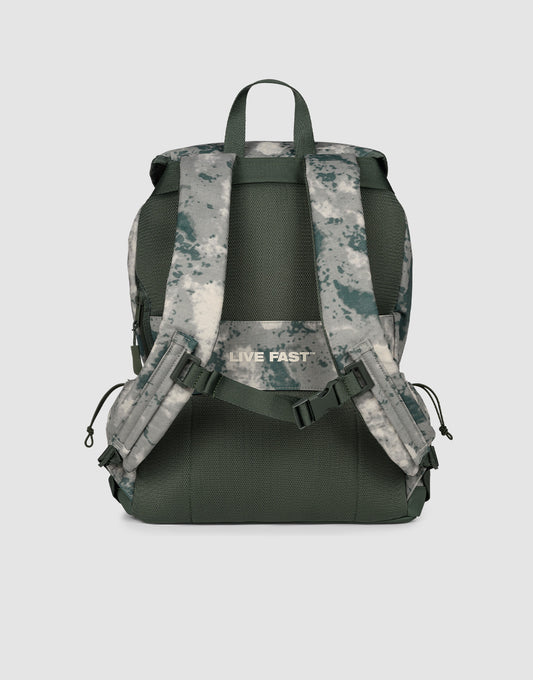 The LFDY Travel Backpack by LIVE FAST DIE YOUNG is a green and gray camouflage rucksack with adjustable padded shoulder straps, "LIVE FAST" in white on the back strap, shown from the back. Capacity: 25 liters.