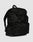The LFDY Travel Backpack by LIVE FAST DIE YOUNG is a black, 25L rucksack with a top flap and two buckles, front zippered pocket, side pockets, and adjustable shoulder straps, shown on a plain light gray background.