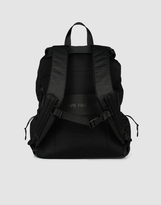 The LFDY Travel Backpack by LIVE FAST DIE YOUNG, in black, is shown from the back with adjustable shoulder straps, a top handle, zippered side pockets, an adjustable chest buckle, and 25L capacity against a plain light gray background.