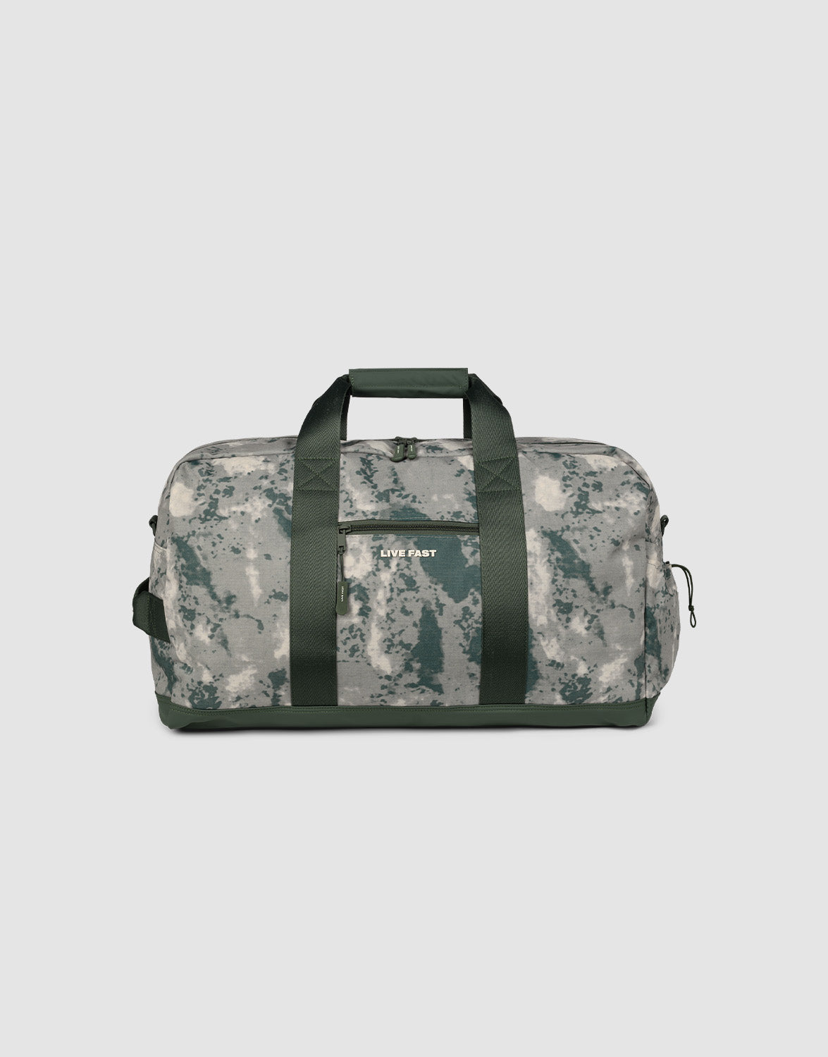 The LIVE FAST DIE YOUNG LFDY Weekender 60 is a 43L sport bag in green/gray camo with black handles, a front pocket, and “LIVE FAST” in white on the front. Comes with a shoulder strap and is shown on a plain light background.