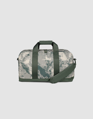 The LFDY Weekender 50 by LIVE FAST DIE YOUNG has dark green handles and strap, a gray-white marbled camo pattern, a spacious 50L compartment, and a removable shoulder strap for versatile use.