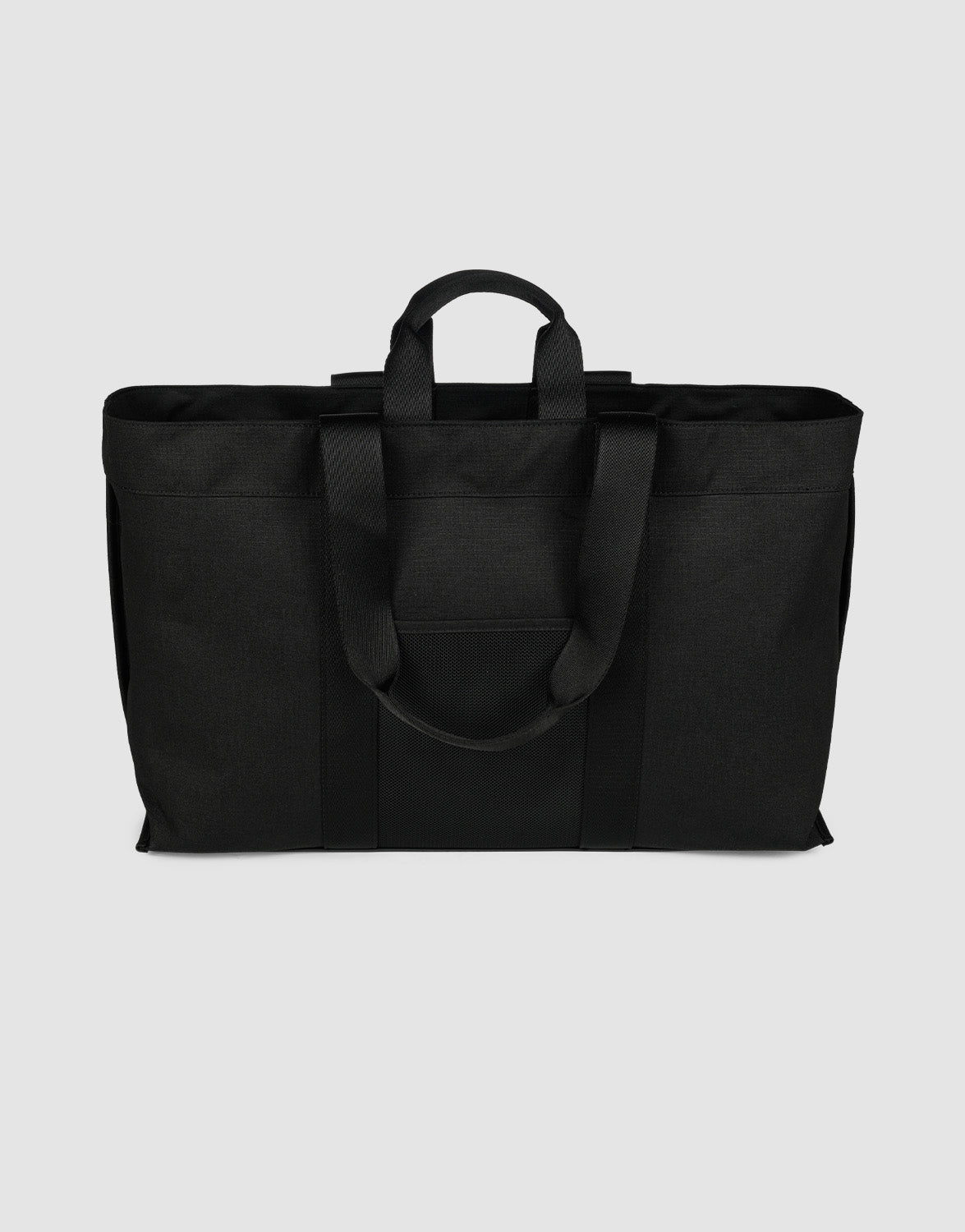 The LFDY Utility Bag by LIVE FAST DIE YOUNG is a black tote made of durable polyester, with two short handles, two long shoulder straps, and a spacious main compartment, shown on a plain light gray background.