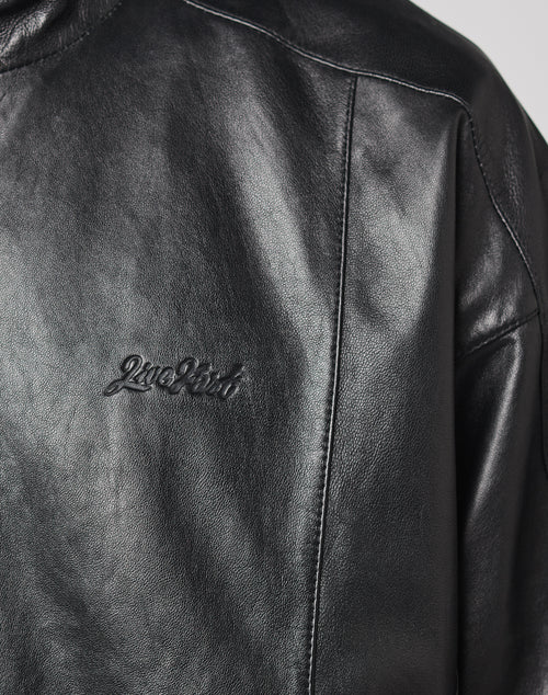 Close-up of the LIVE FAST DIE YOUNG Live Fast Leather Trackjacket, made from 100% leather, featuring a subtle 2nd Shot embossed logo on the left chest, with visible seams and a smooth leather texture.