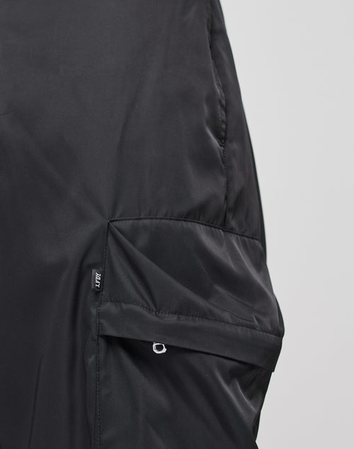 Close-up of the LIVE FAST DIE YOUNG Nylon Cargo jacket’s black sleeve, crafted from smooth polyester with a zippered pocket, small pull tab, and JLU tag. Regular Fit Cargotaschen details offer added style and practicality.