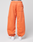 A person wears LIVE FAST DIE YOUNG's LFDY 40 Wide Cuff Jogger—loose-fitting, bright orange sweatpants with side pockets, an elastic waistband, and a back pocket. Only the lower body and white sneakers are shown against a plain white background.