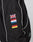 The LFDY Canvas Jacket by LIVE FAST DIE YOUNG is a black racing jacket with white piping, multicolor logo embroidery of the UK, France, Estonia, and Germany on the sleeve next to a zip pocket and sleek stand-up collar.