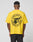 Someone is shown from behind wearing the LIVE FAST DIE YOUNG LFDY Circle Dog Tee, a bright yellow oversize fit t-shirt with a large circular graphic of a dog’s head and the text LIVE FAST, DIE YOUNG, BEWARE OF DOGS on the back.