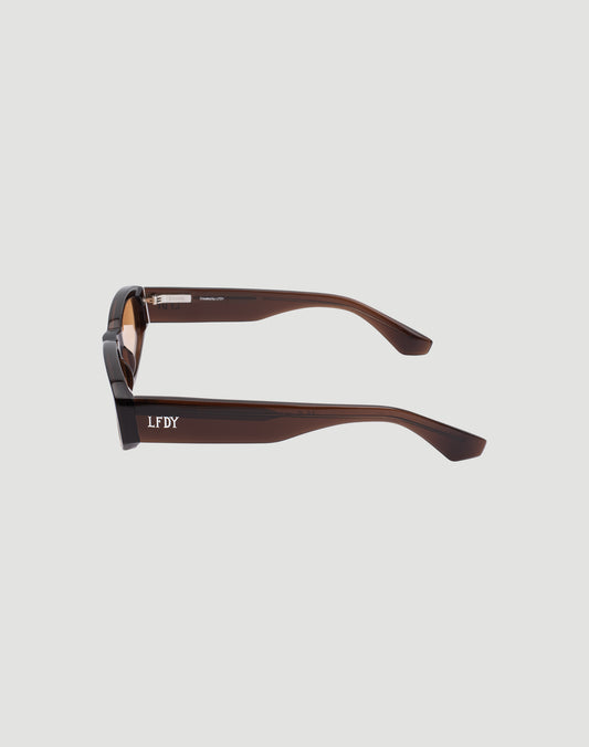 Side view of brown rectangular LFDY x Chimi Shades 09 sunglasses by LIVE FAST DIE YOUNG with thick arms and white LF DY lettering. CR39 lenses provide UV protection. Plain light gray background.
