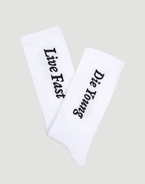 The LIVE FAST DIE YOUNG Live Fast Die Young Socks (2 Pack) feature white ribbed socks with black Live Fast and Die Young text, crafted from a comfortable Baumwolle, Polyamid, and Elastan blend, shown on a light gray background.