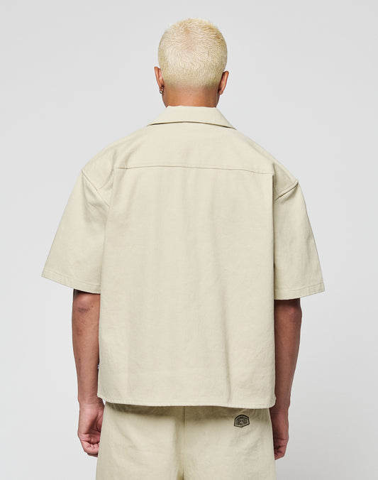 A person with short, bleached blonde hair is shown from behind, wearing the LIVE FAST DIE YOUNG LFDY Twill Shirt and matching shorts made from 100% cotton, set against a plain white background.
