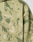 Close-up of the LIVE FAST DIE YOUNG Camo Hooded Zip in green and beige camouflage Oversize Fit, featuring Live Fast embroidered in white on the chest.