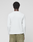 A person with short curly hair stands with their back to the camera, wearing a LIVE FAST DIE YOUNG Basic Waffle Longsleeve and olive green oversize fit pants with a back pocket, set against a plain light background.
