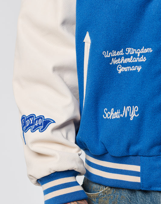 A close-up of the LFDY x Schott NYC Varsity Jacket by LIVE FAST DIE YOUNG, showing blue and white sleeves with chenille patches, a NY 40 patch, and embroidered United Kingdom, Netherlands, Germany, Schott NYC text.