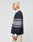A person with short, bleached blond hair stands in profile against a plain background, wearing the LIVE FAST DIE YOUNG LFDY Striped Polo over a white collared shirt and beige cotton twill pants.