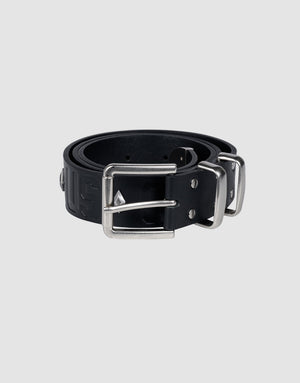 The LFDY Signature Belt by LIVE FAST DIE YOUNG, in black, is rolled up with a rectangular silver buckle and stud accents, displayed on a light gray background.