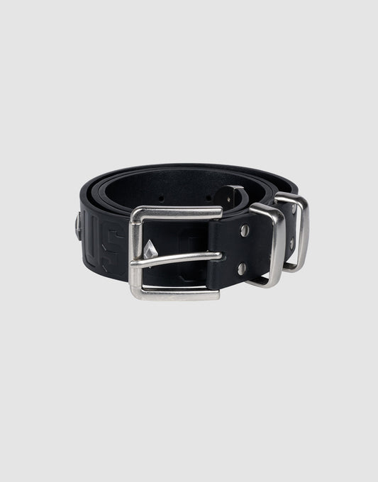 The LFDY Signature Belt by LIVE FAST DIE YOUNG, in black, is rolled up with a rectangular silver buckle and stud accents, displayed on a light gray background.