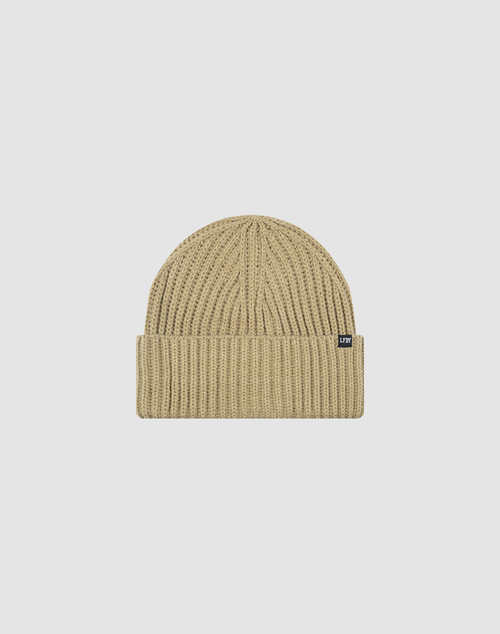 The LIVE FAST DIE YOUNG Rib Knit Beanie is a beige, one size hat with ribbed knit, folded cuff, and a small black Flag-Label tag on the side, made from cozy Polyamid and shown against a plain white background.