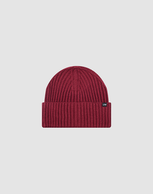 The LIVE FAST DIE YOUNG Rib Knit Beanie is maroon, one size, with a ribbed knit design, folded brim, and a small black rectangular flag-label on the side, shown against a plain light gray background.