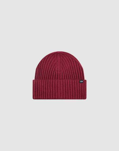 The LIVE FAST DIE YOUNG Rib Knit Beanie is maroon, one size, with a ribbed knit design, folded brim, and a small black rectangular flag-label on the side, shown against a plain light gray background.