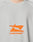 The LFDY Sports Longsleeve by LIVE FAST DIE YOUNG features a light gray color, an abstract orange graphic, and bold LIVE FAST™ text on the chest, all in an oversize fit for a relaxed, modern style.