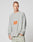 A man with short hair wears the light gray LFDY Sports Longsleeve by LIVE FAST DIE YOUNG, featuring Raglan sleeves and an orange LIVE FAST graphic, paired with light pants. He stands against a plain, light background, looking to the side.