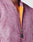 Close-up of a person wearing the LIVE FAST DIE YOUNG Washed Bomber Jacket in mauve, featuring a gold zipper, bright yellow-orange lining, and subtly vintage washed finish. Only the neck and chin are visible.
