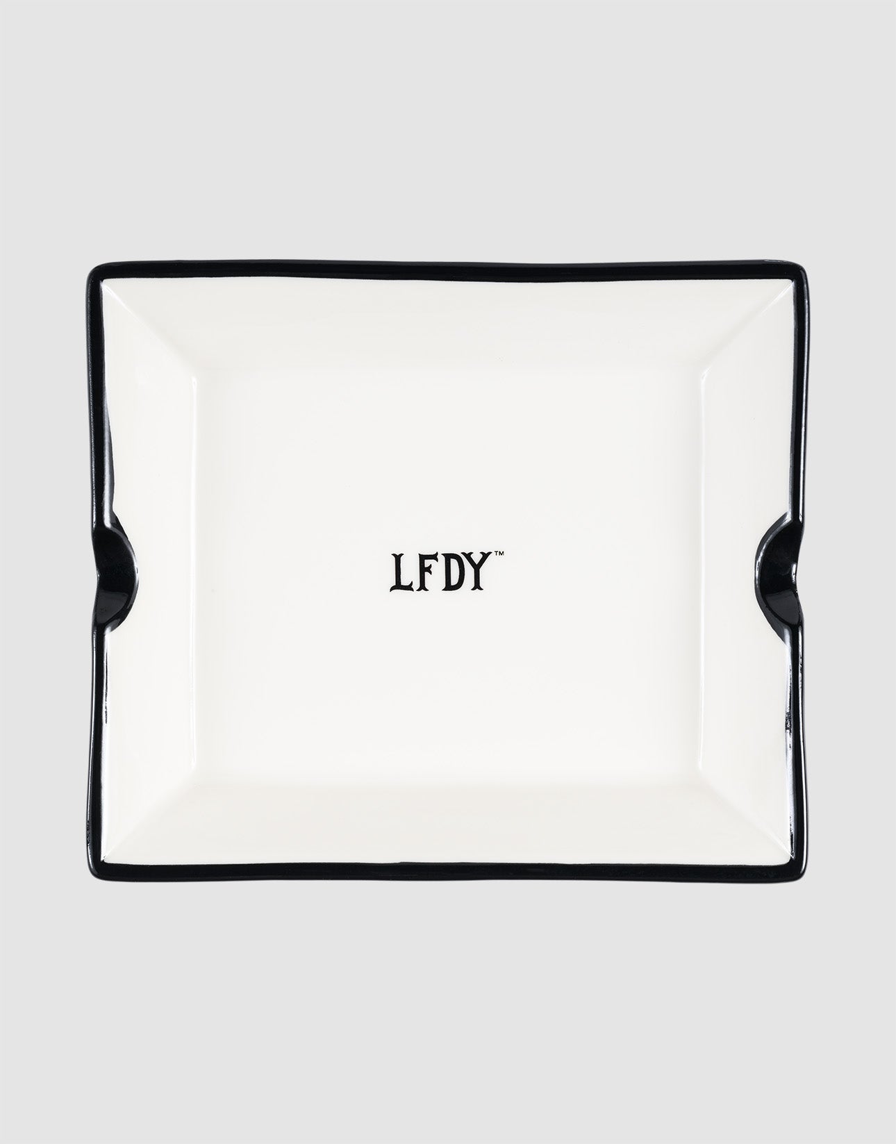 The LFDY Ashtray by LIVE FAST DIE YOUNG is a rectangular white porcelain ashtray with black trim, two notches, and a central black "LFDY" logo. Model: LF2603-20136.