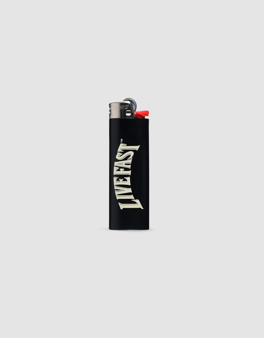 The LFDY x The Bulldog Lighter by LIVE FAST DIE YOUNG is a black BIC J26 with a chrome cap and red ignition, bold white LIVEFAST text on the front, set on a light gray background. Provides up to 3000 ignitions.| plain 