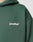 Close-up of the dark green Basic 360 Hooded by LIVE FAST DIE YOUNG, featuring LiveFast™ in white on the chest. Made from a soft cotton-polyester blend; image shows the upper left section without revealing the wearer’s face.