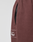 Close-up of a brown Wide Cuff Jogger from LIVE FAST DIE YOUNG, showing a black zippered pocket, partial white "Fast" text, soft French Terry-like fabric, visible seam, and elastic waistband.