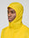 A person models the bright yellow Live Fast Performance Running Jacket by LIVE FAST DIE YOUNG, featuring a visor hood and Regular Fit, standing out against a plain light gray background.