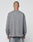 A person with a shaved head stands with their back to the camera, wearing the LIVE FAST DIE YOUNG Basic Longsleeve and matching pants in gray, both made from 100% Baumwolle, against a plain light background.