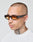 A man with a shaved head and tattooed neck wears LFDY x Chimi Shades 09 by LIVE FAST DIE YOUNG, featuring amber-tinted rectangular frames, paired with a white shirt against a plain light background.