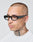 A person with a shaved head, neck and scalp tattoos, wearing a white shirt and LFDY x Chimi Shades 09 by LIVE FAST DIE YOUNG, looks slightly to the side against a plain background.