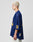 A person with short, bleached blonde hair in profile wears the LFDY Mesh Jersey by LIVE FAST DIE YOUNG—a blue jersey with yellow accents, Web-Patch details, V-Ausschnitt collar, Oversize Fit, and number 13 on the sleeve. Plain light gray background.