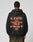 A person, facing away against a plain light background, wears an oversize fit black Print Over Hooded by LIVE FAST DIE YOUNG with bold orange LIVE ITS FUCK DIE YOUNG FOREVER FAST text on the back. Made from Baumwolle (cotton).
