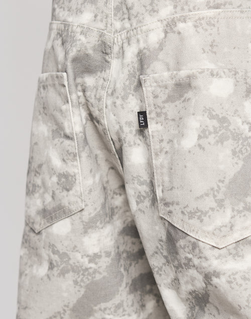 Close-up of the back of LIVE FAST DIE YOUNGs Live Fast Canvas Pants in light gray and white camouflage, baggy fit, with two back pockets and a small black tag on one reading 1017 in white.