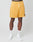 A person wearing yellow LFDY Oval Mesh Shorts by LIVE FAST DIE YOUNG, featuring a drawstring elastic waistband, regular fit, and small logo on the left leg, stands against a plain white background with white socks and sneakers.