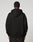 A person faces away from the camera, wearing the LIVE FAST DIE YOUNG Live Fast Plain Hooded black oversize hoodie and matching soft Baumwolle pants, set against a plain light background.