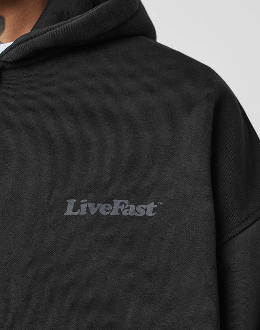 A close-up of a person wearing the LIVE FAST DIE YOUNG Basic 510 Hooded Zip in black. Only their neck and part of the chin are visible.