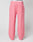 The Live Fast Boucle Pants by LIVE FAST DIE YOUNG are wide fit, pink fleece pants featuring an Elastikbund, side pockets, a straight leg cut, and a small front right patch pocket, shown on a mannequin against a plain background.