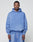 A man faces forward in a matching light blue LIVE FAST DIE YOUNG Basic Evidence Hooded sweatshirt and sweatpants with an oversize fit, front pocket, and small chest text, set against a plain background to highlight the relaxed style.