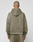 A person with a shaved head faces away from the camera, wearing the LIVE FAST DIE YOUNG Basic +49 Hooded and matching pants in olive green, both in an oversize fit, against a plain light gray background.