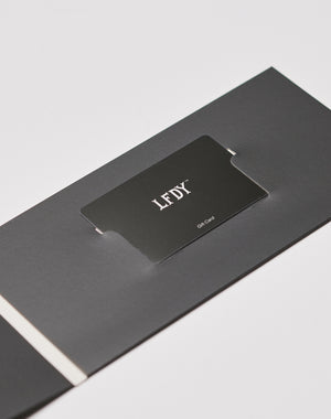 A LIVE FAST DIE YOUNG Gift Card Wrapping showcases a black gift card in a matching holder on a white background, featuring the LFDT logo in white at the center.| plain 